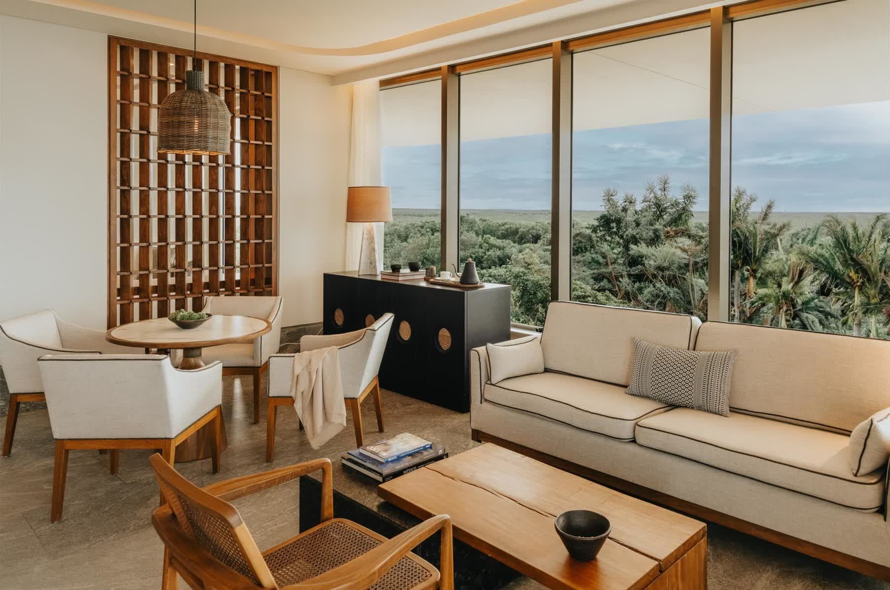 An oceanfront suite with doors open to the sea