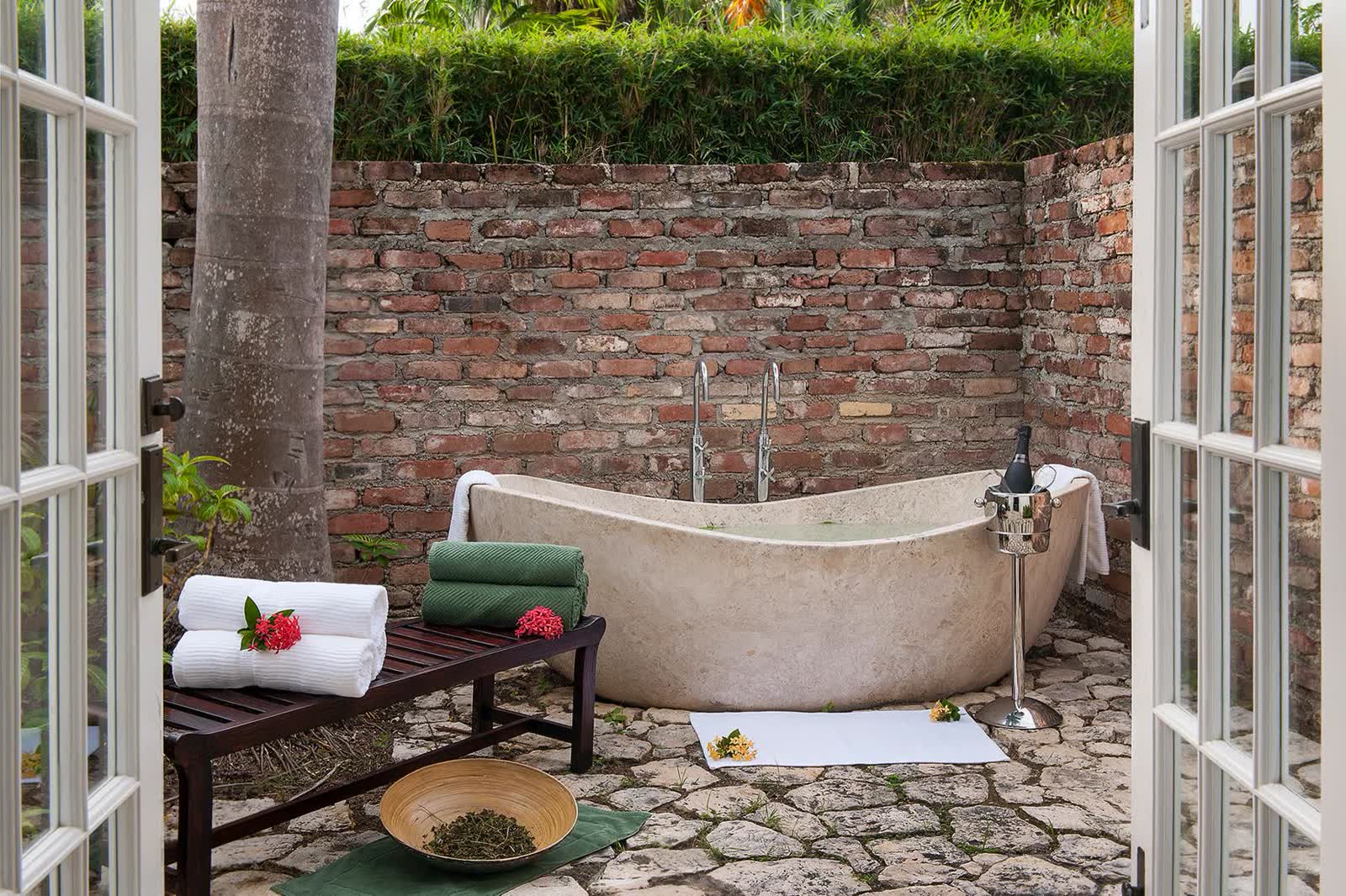 A private herbal bath prepared with flowers and greenery